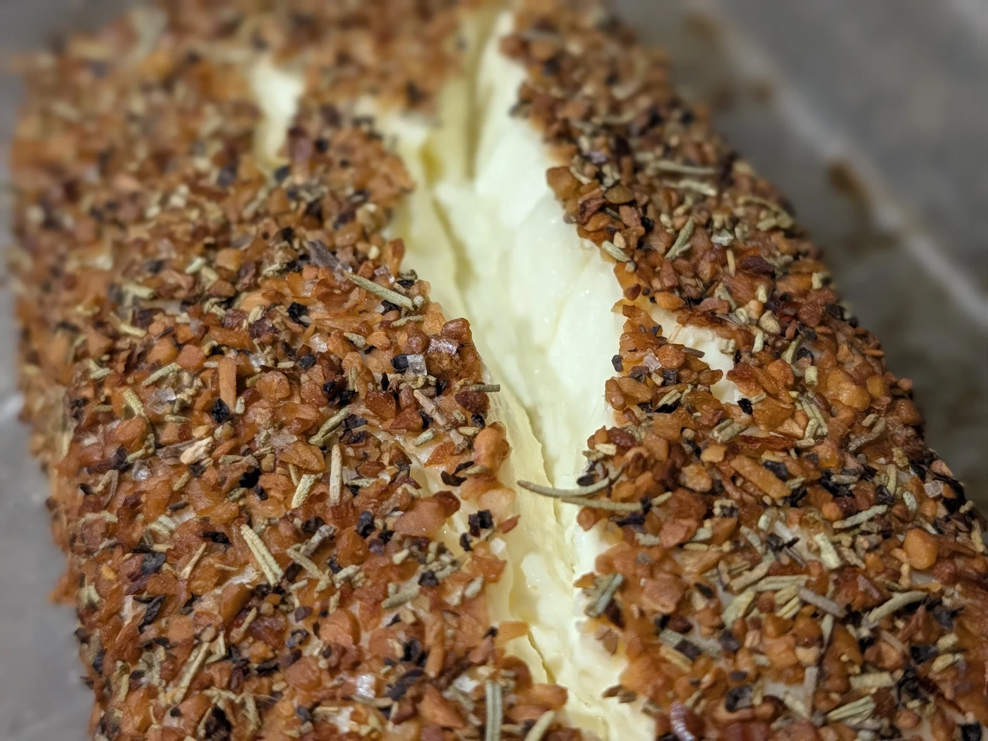 Side angle of hot smoked cream cheese with molten center and caramelized golden crust